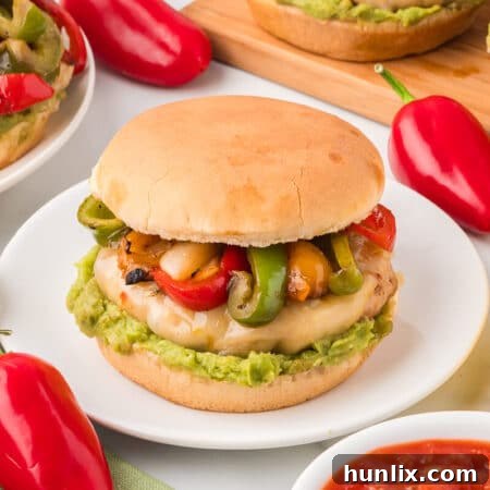 A chicken fajita burger on a plate.