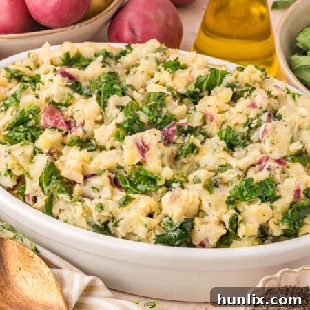 Olive Oil Mashed Potatoes with Kale & Herbs served in a rustic dish.