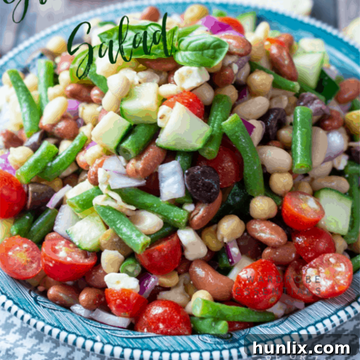 Greek Bean Salad with 4 types of beans, a variety of veggies, feta cheese, and a light zesty dressing.