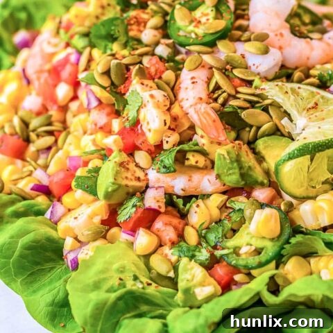 Mexican Shrimp Salad, fresh and vibrant, with perfectly seasoned shrimp, corn, tomatoes, jalapeños, avocado, Mexican vinaigrette, and toasted pumpkin seeds.