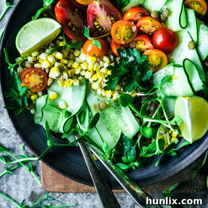 Mexican lentil salad, a summery take on a vegan classic, with tomatoes, cucumber, corn, cilantro, and a zesty lime vinaigrette.
