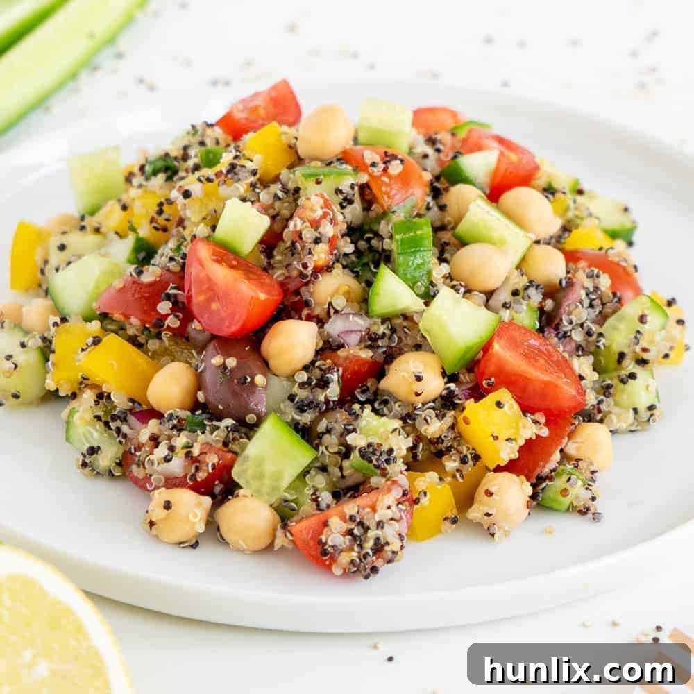 Healthy Mediterranean quinoa salad made with seasonal and colorful ingredients, naturally vegan, gluten-free, and dairy-free.