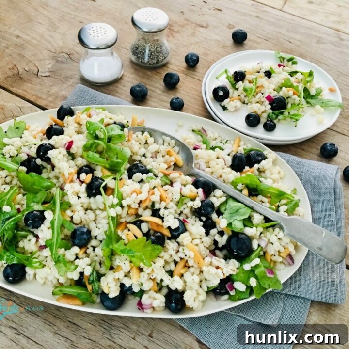 Cold barley grain salad with juicy blueberries for sweetness, baby greens for texture, toasted almonds for crunch, and a vibrant basil vinaigrette.