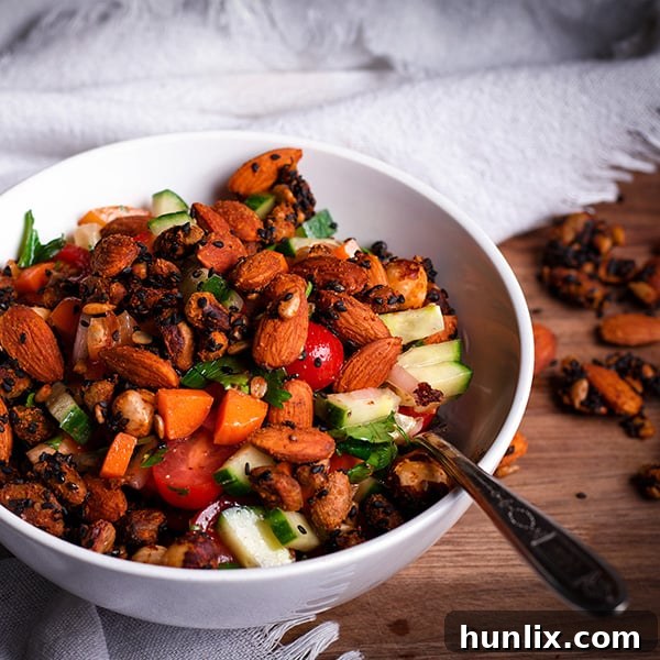 Israeli Salad, a delicious and fresh mix of finely chopped vegetables and herbs, dressed with Pomegranate Vinaigrette and crunchy Ja’ala nut and seed mix.