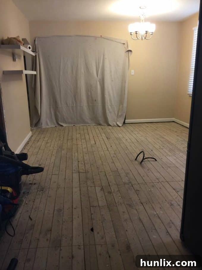 Kitchen renovation progress: Day 1 after complete demolition, revealing bare wood floors