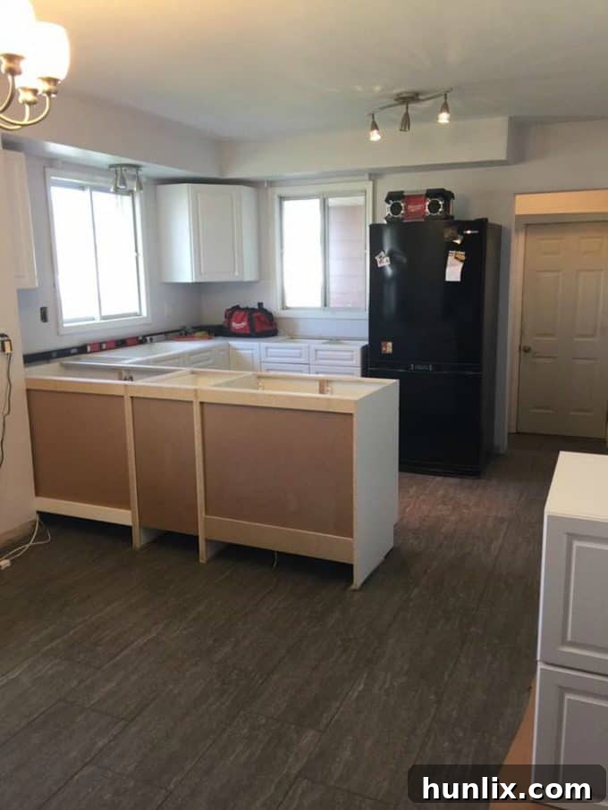 Kitchen renovation progress: First kitchen cabinets being installed, defining the layout