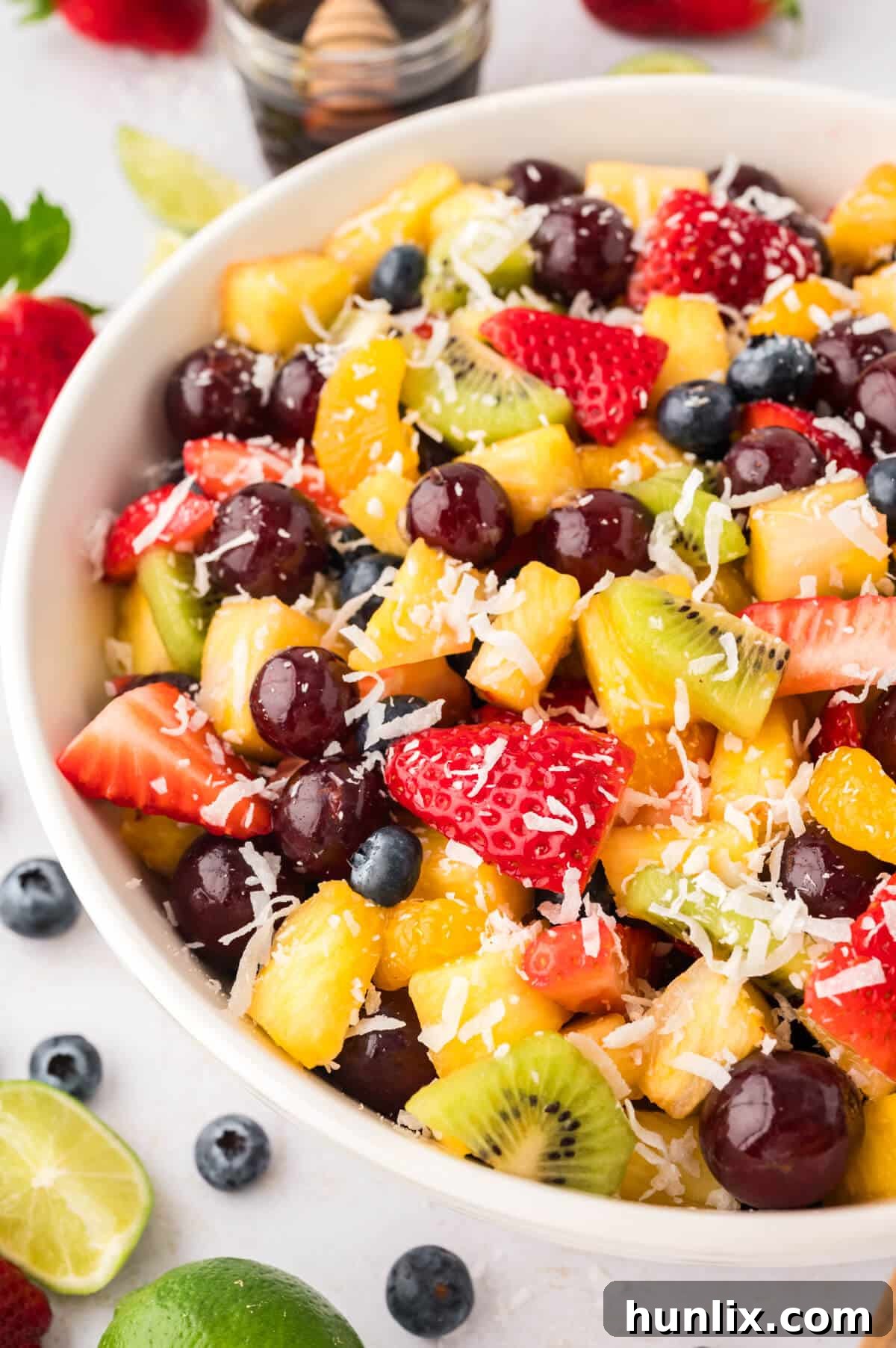 A bowl of rainbow fruit salad, showcasing a spectrum of fresh fruits, looking vibrant and appealing.
