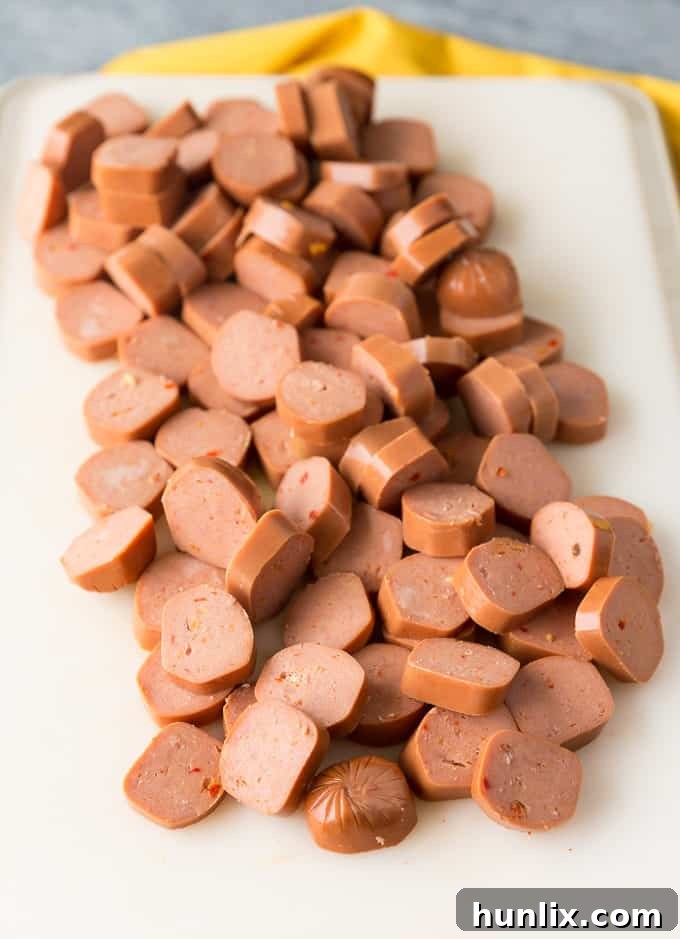 A pot of hearty spicy chili simmering on the stove, ready to top a batch of nachos.