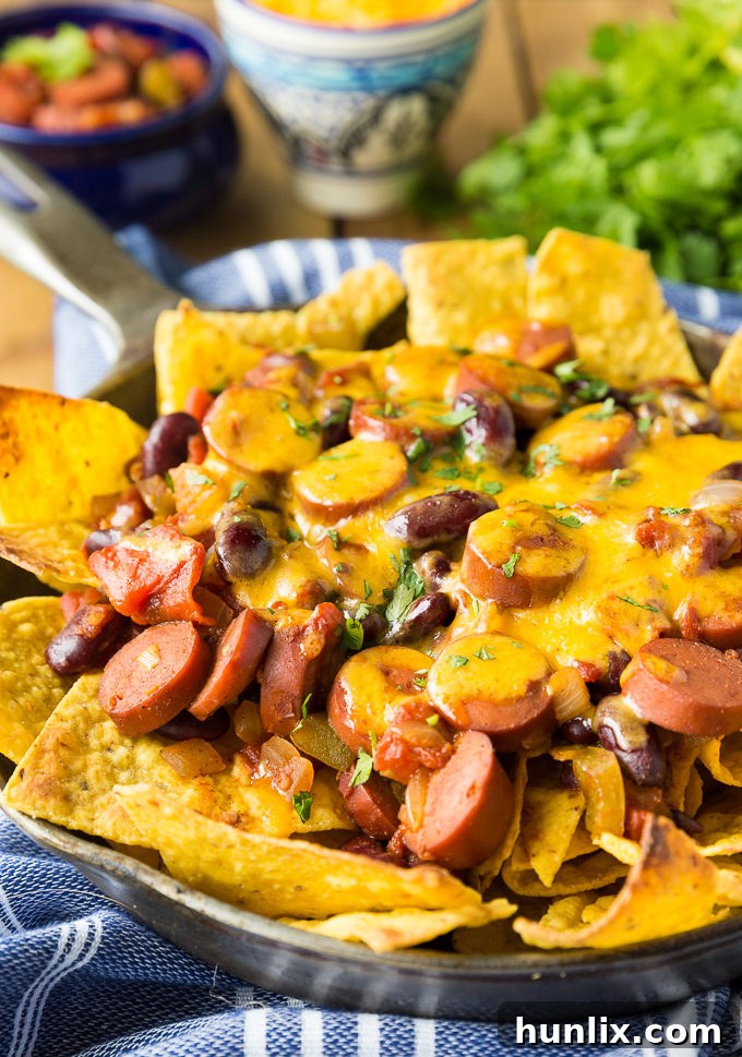 A serving of Spicy Chili Nachos, loaded with melted cheese and fresh cilantro, showing the perfect blend of heat and flavor.