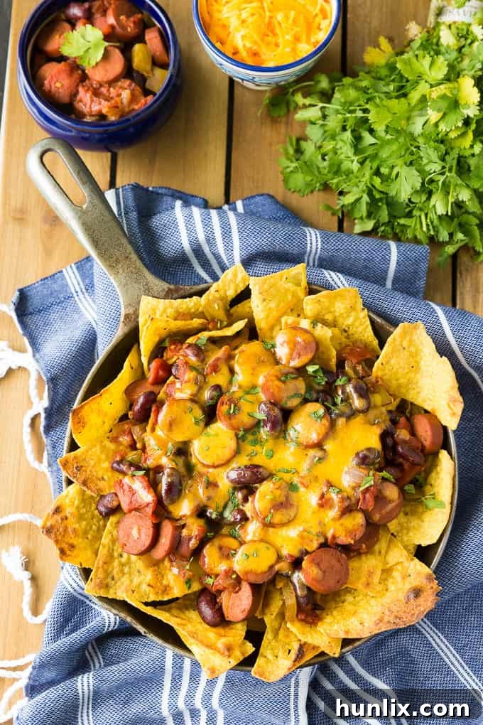Spicy Chili Nachos on a platter, showcasing the rich chili, gooey cheese, and crisp tortilla chips, ready to be enjoyed.