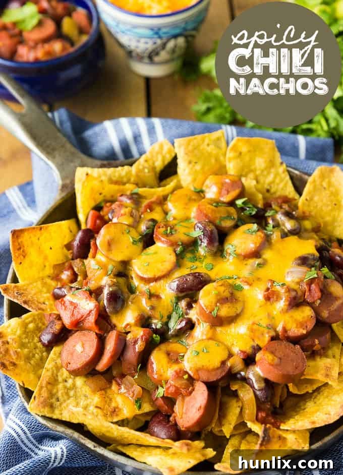 Spicy Chili Nachos, a perfect blend of chili dogs and nachos, ideal for a party appetizer with a lot of flavor and a little heat.