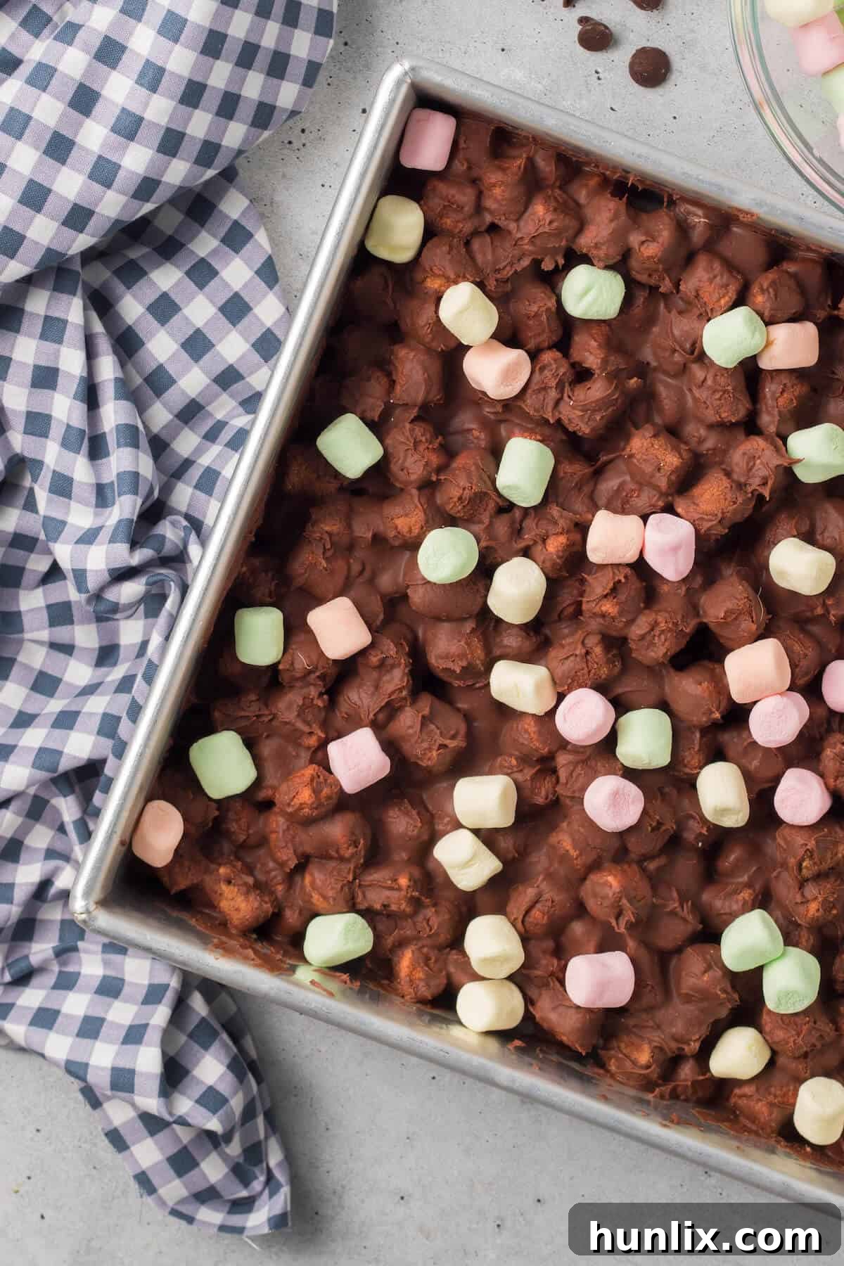 Chocolate confetti bars in a pan, showcasing their colorful marshmallow speckled top.