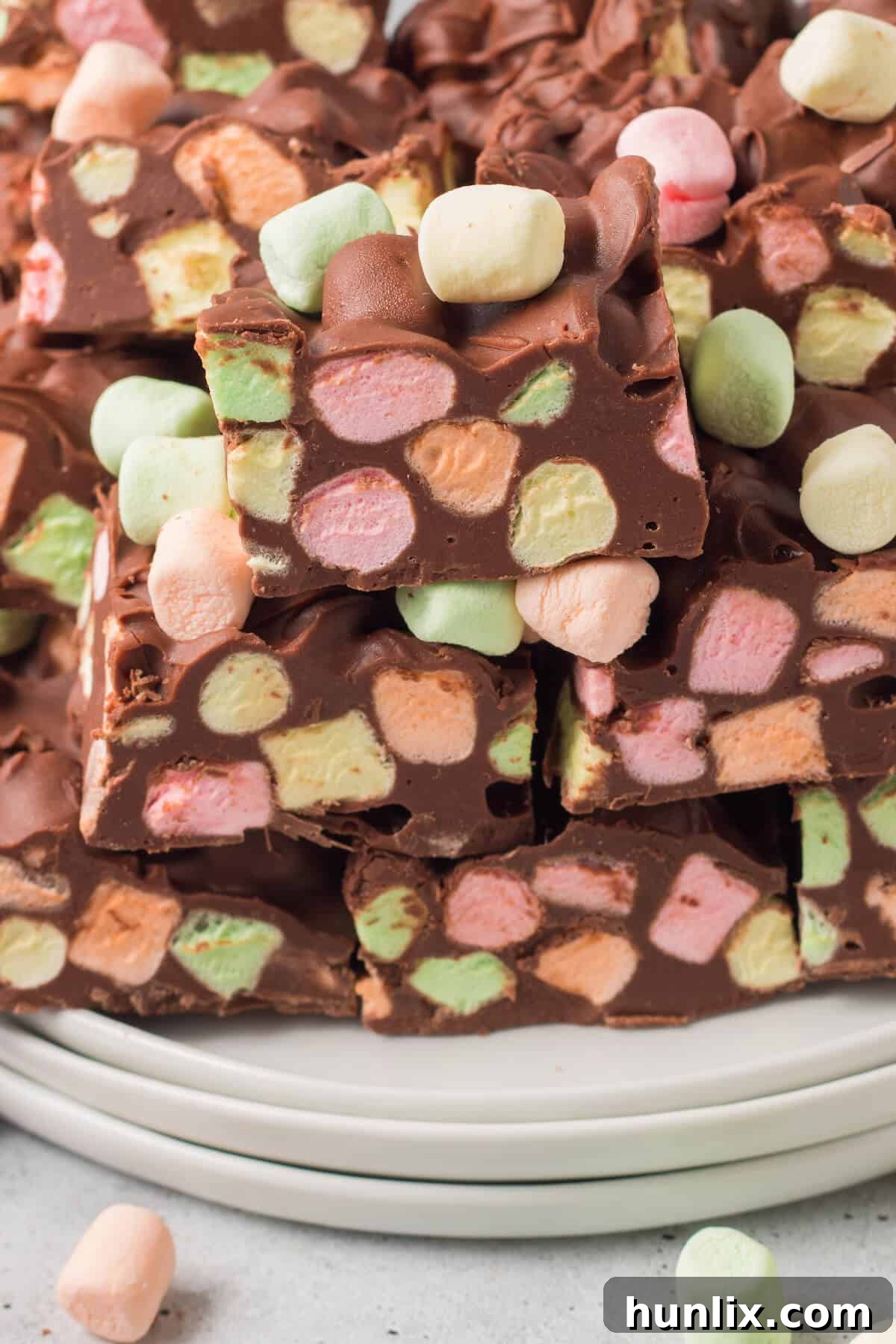 A beautiful pile of freshly cut Chocolate Confetti Bars on a white plate, ready to be served.