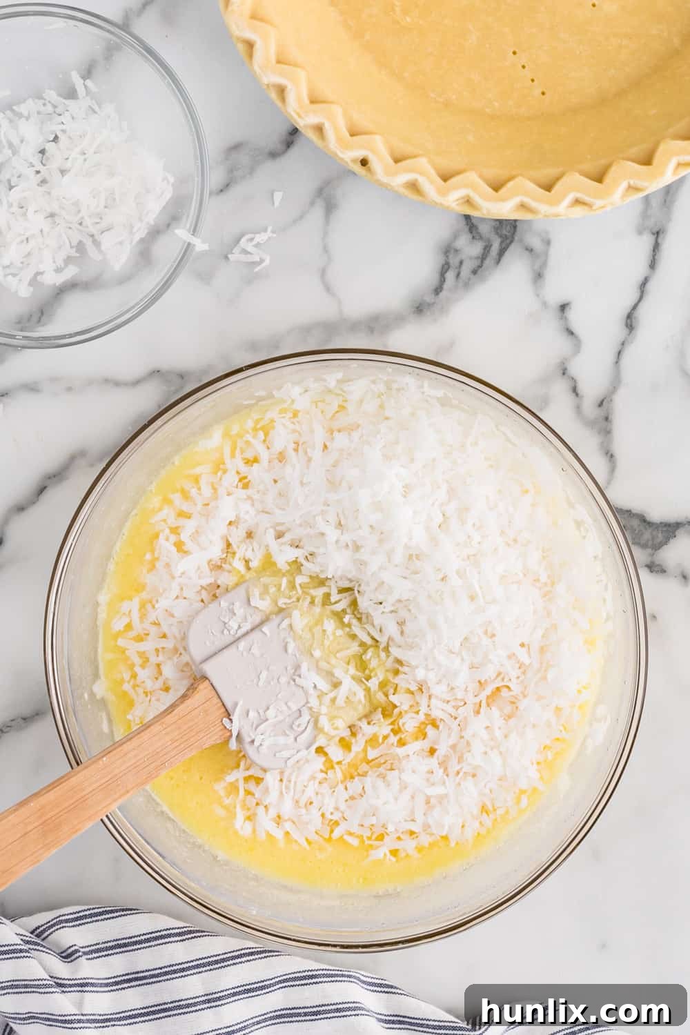 Luscious Coconut Cream Pie 4 Mixing the filling ingredients for coconut pie in a large glass bowl.