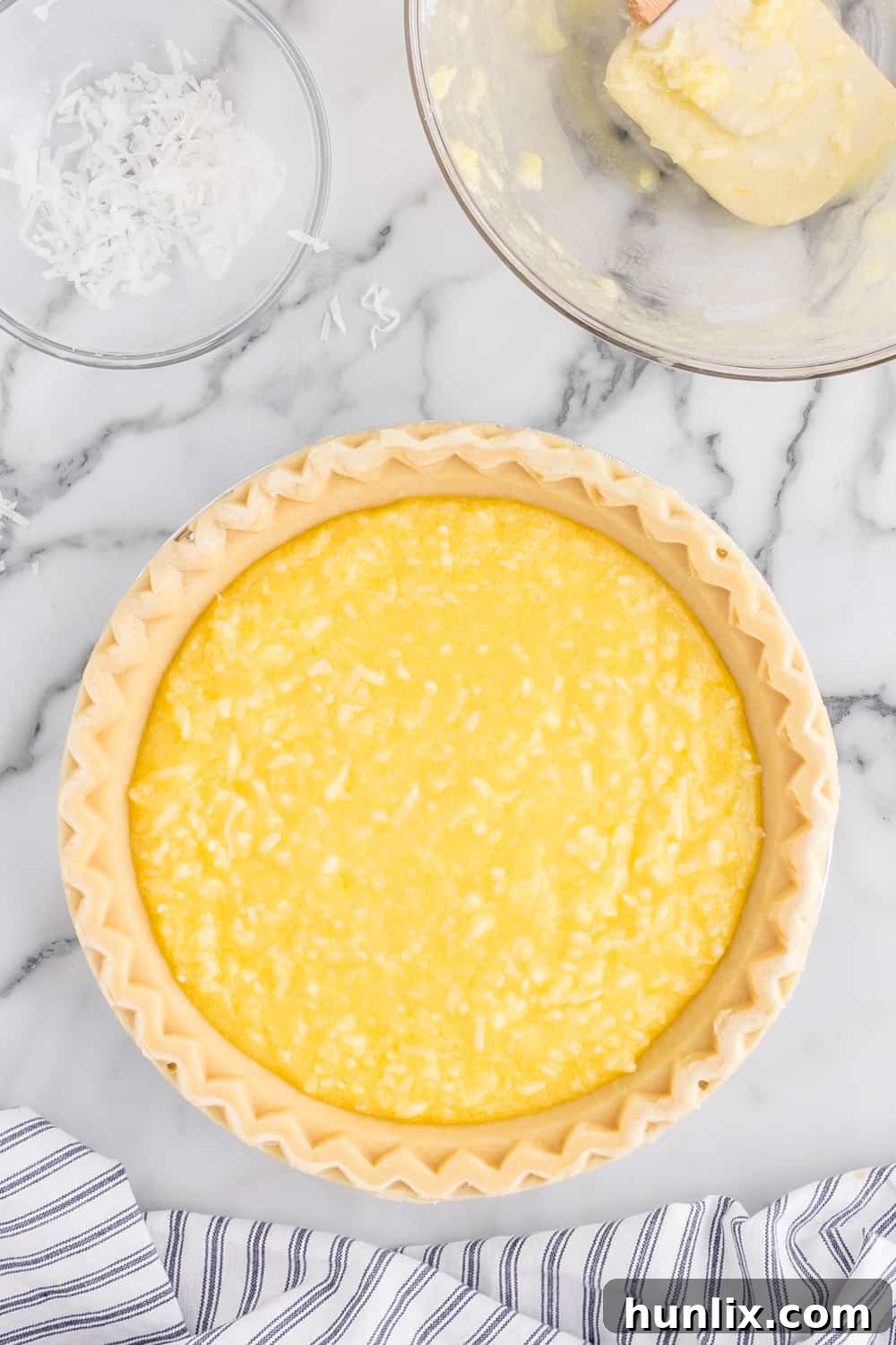 Luscious Coconut Cream Pie 5 The smooth coconut pie filling poured into an unbaked pie shell, ready for the oven.