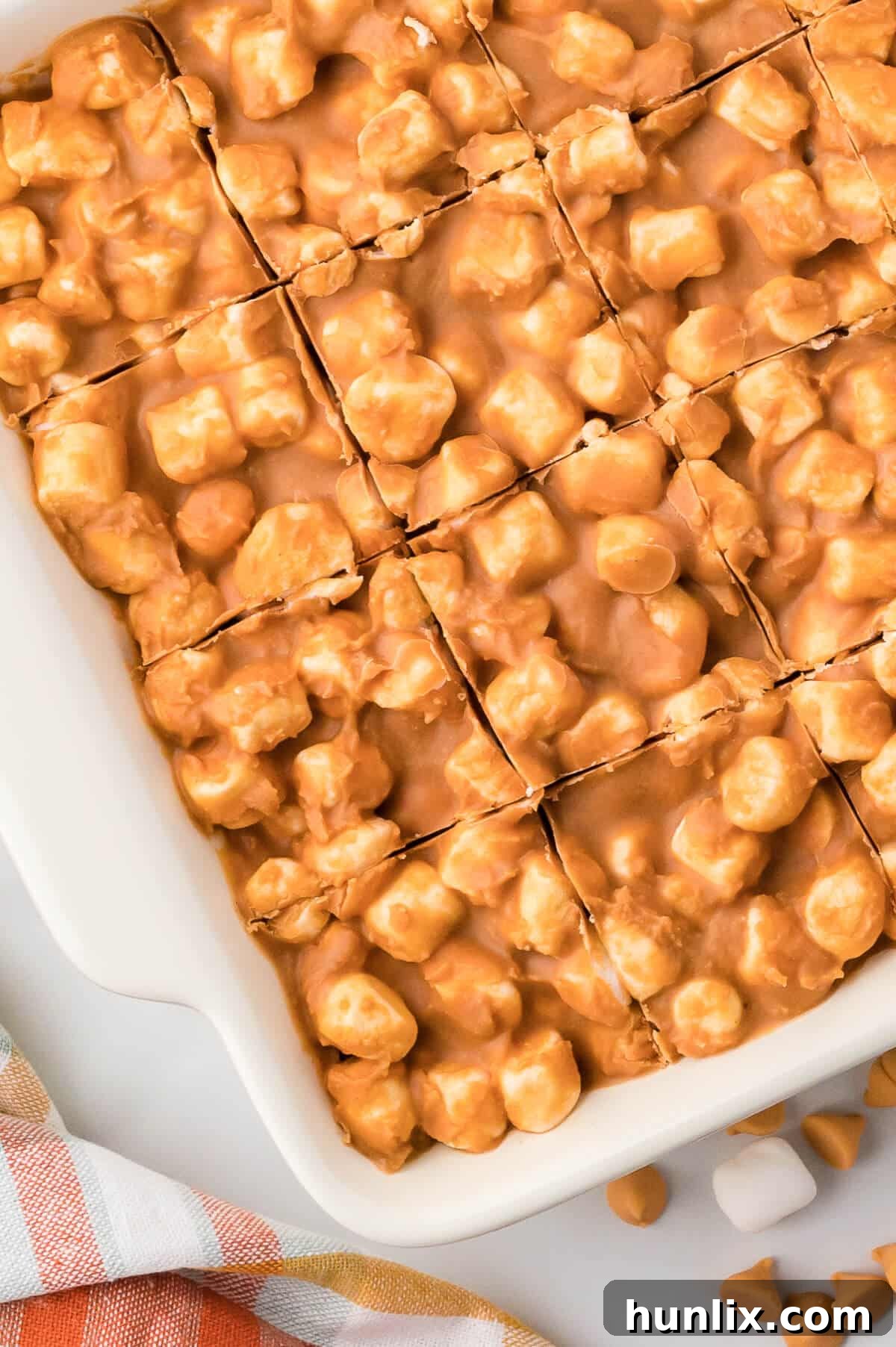 A pan of marshmallow bars with cut marks.