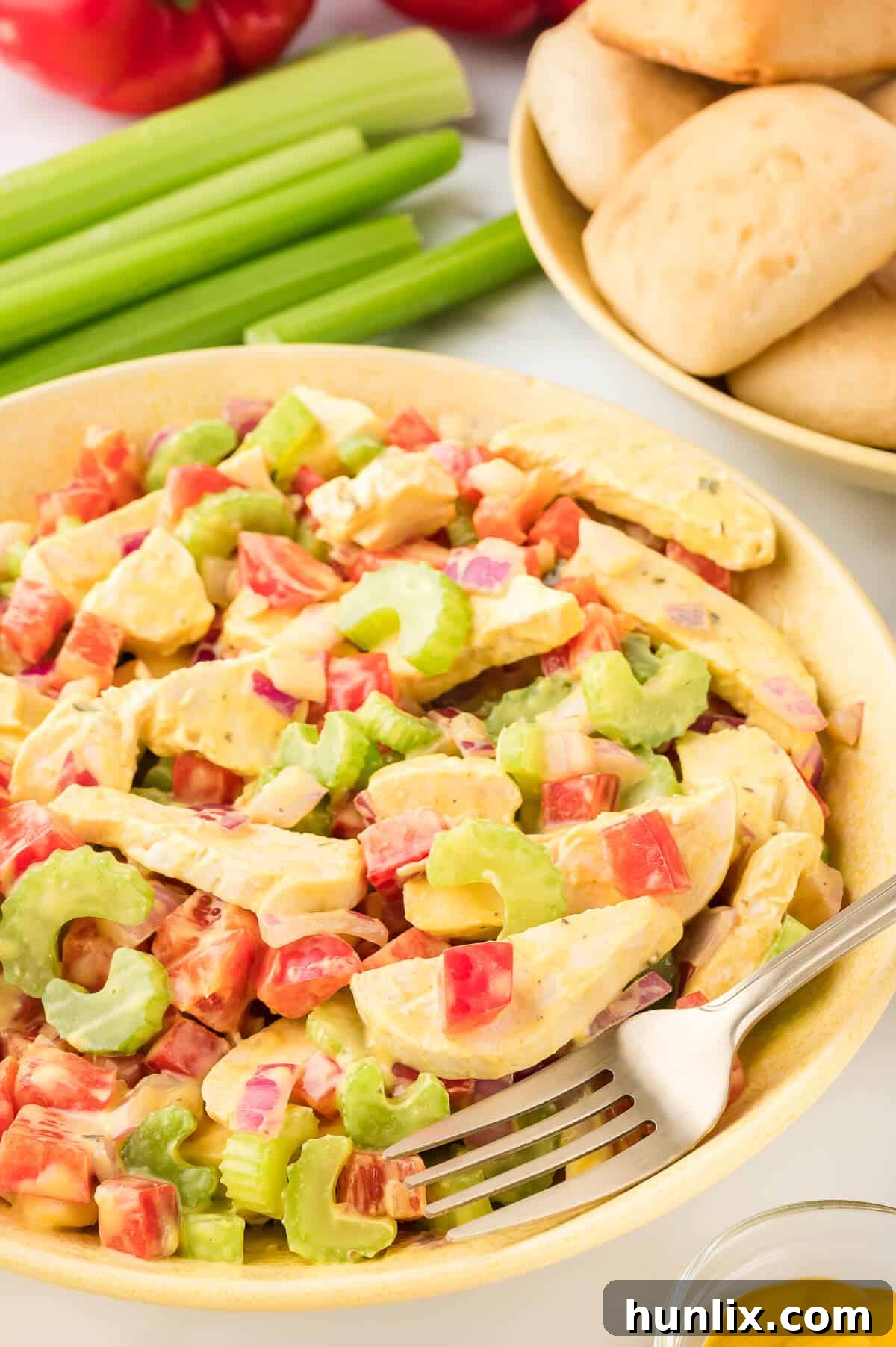 Mustard chicken salad in a bowl with a fork.