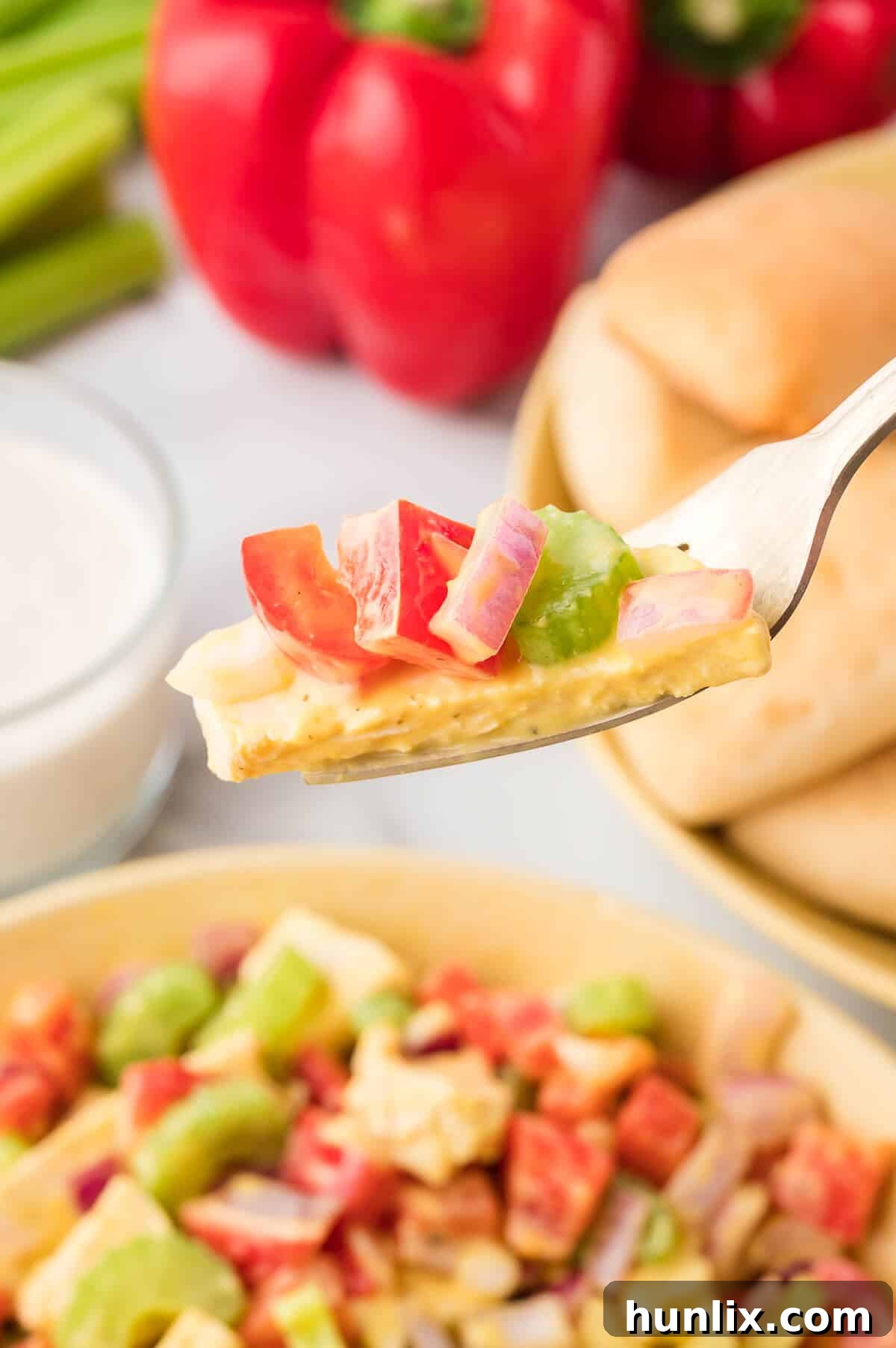Mustard chicken salad on a fork.