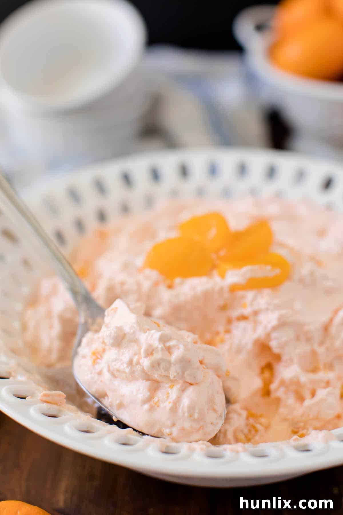 Orange Creamsicle Salad - The fluffiest dessert! You'll dream about your childhood ice cream cravings with this creamy fruit salad with cottage cheese, Jello, and mandarin oranges.