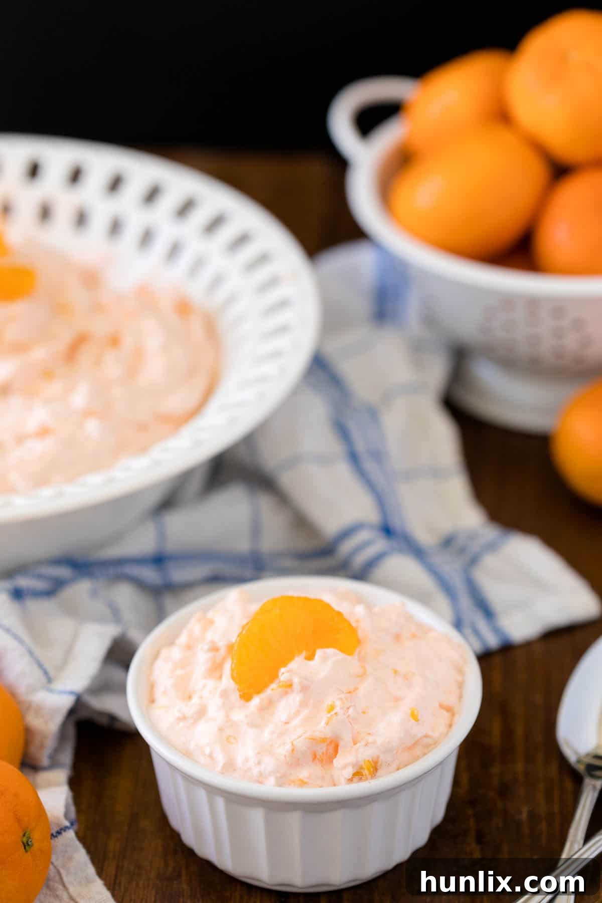Orange Creamsicle Salad - The fluffiest dessert! You'll dream about your childhood ice cream cravings with this creamy fruit salad with cottage cheese, Jello, and mandarin oranges.