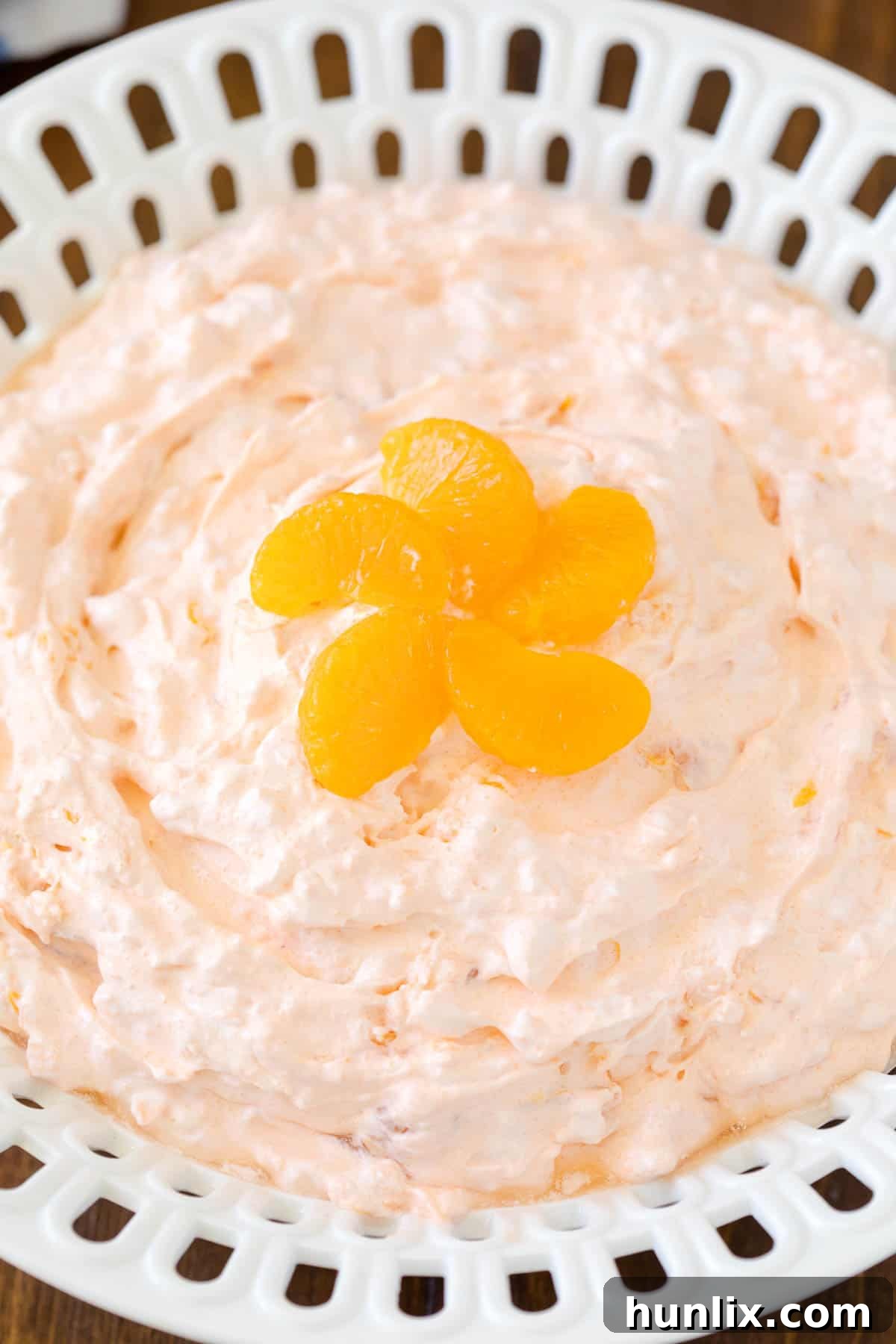 Orange Creamsicle Salad - The fluffiest dessert! You'll dream about your childhood ice cream cravings with this creamy fruit salad with cottage cheese, Jello, and mandarin oranges.