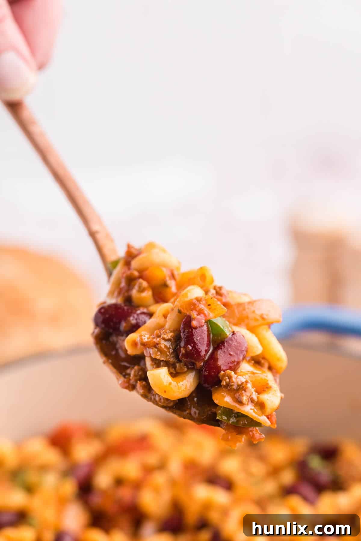 A close-up of Chili Macaroni on a serving spoon, showcasing the rich texture and ingredients.