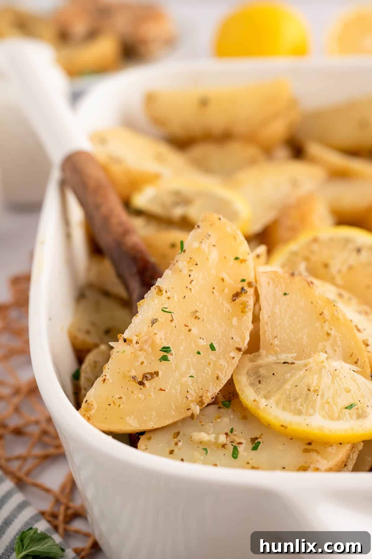 A large pan of freshly baked lemon roasted potatoes, golden and tender.