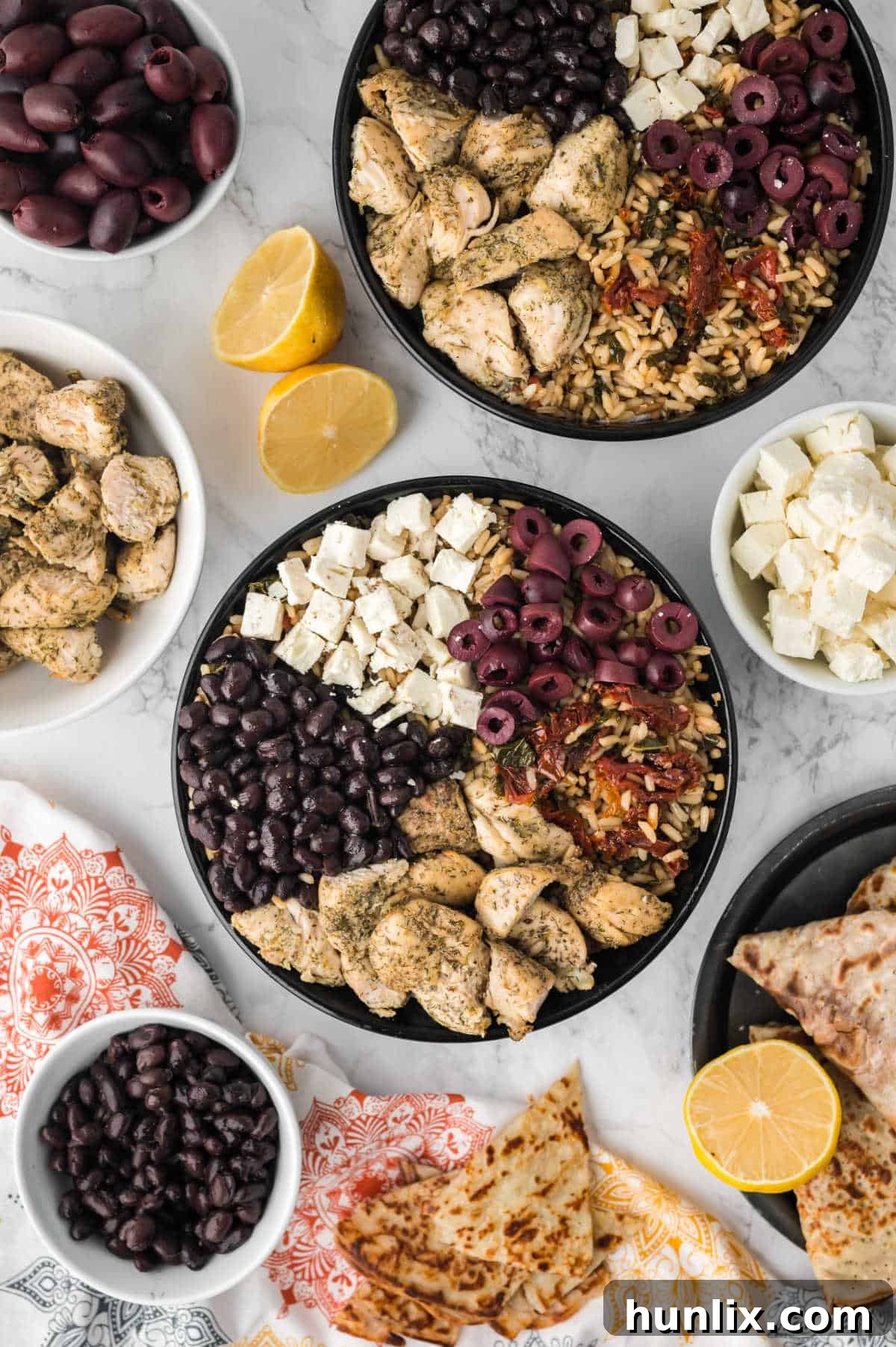 Vibrant Mediterranean Chicken Rice Bowl 2 Mediterranean chicken and rice bowl surrounded by all the ingredients.