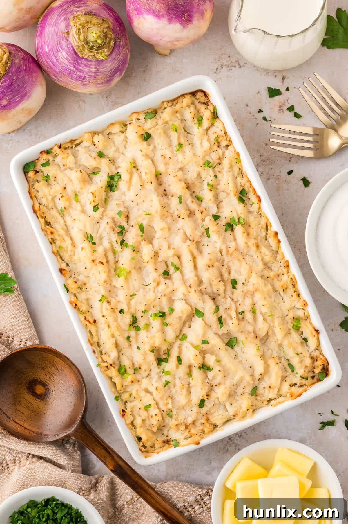 Golden Turnip Delight 5 A close-up shot of the golden-brown turnip casserole in a white pan, showcasing its creamy texture.