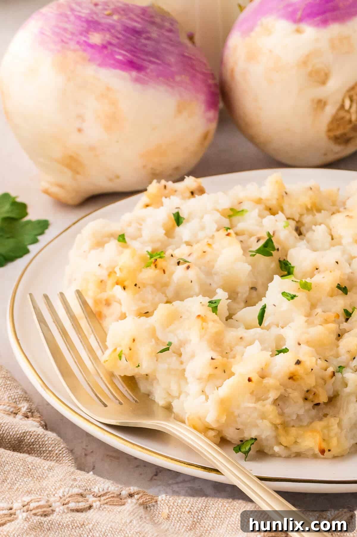 Golden Turnip Delight 7 A serving of turnip casserole presented on a white plate with a fork, emphasizing its delightful texture.