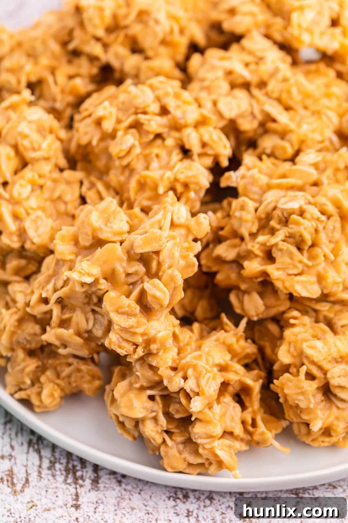 Effortless Butterscotch Treats 5 A selection of delicious no-bake butterscotch cookies artfully arranged on a white plate, ready for serving.