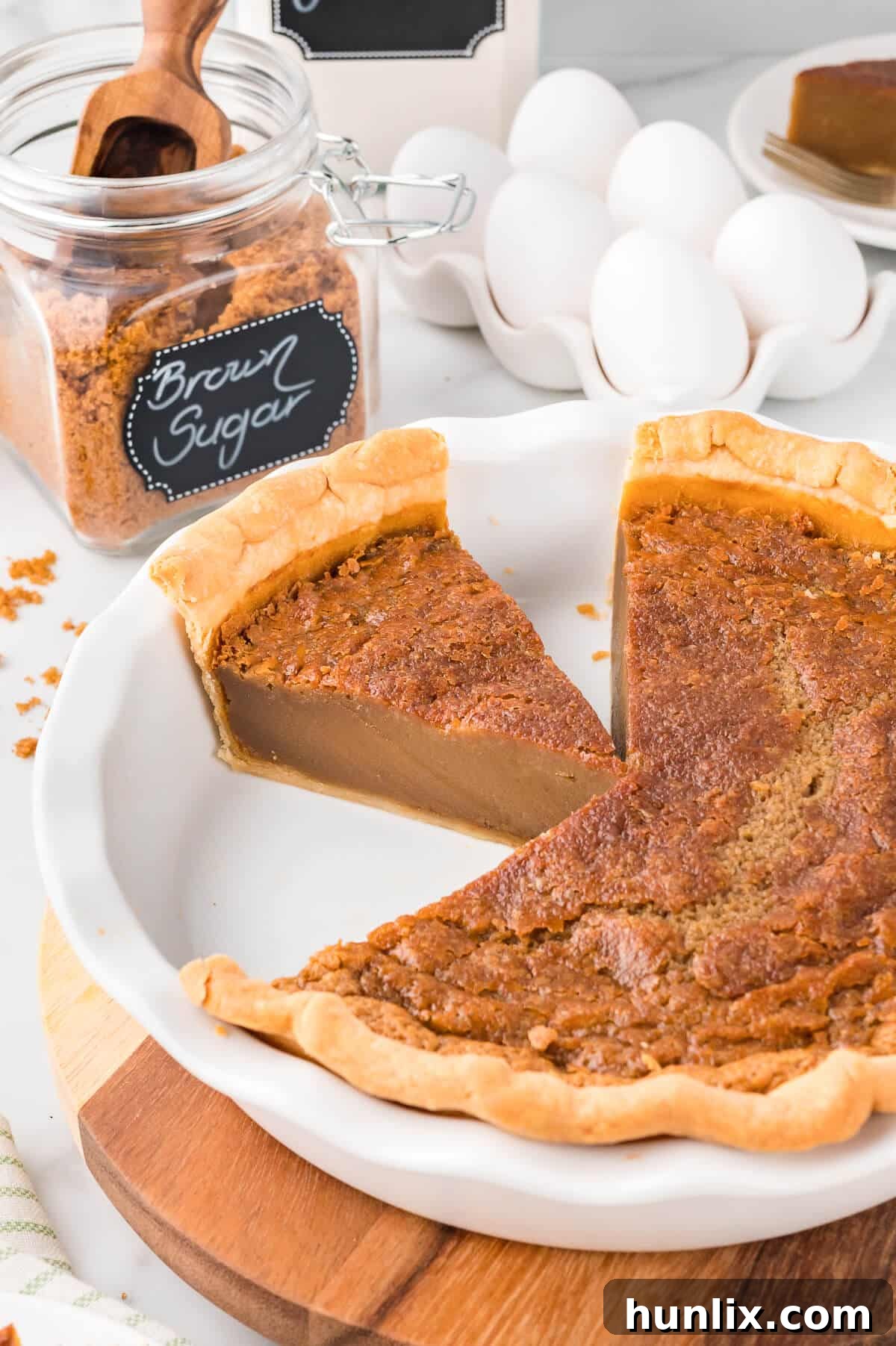 A sugar pie with several slices removed, presented with a rustic feel.