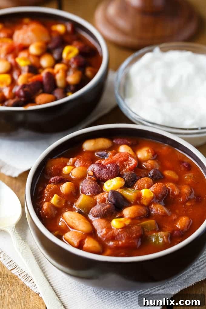 Hearty Bean Chili 2 Bean Chili - The heartiest meat-free chili recipe! Use four different kinds of canned beans in this comfort food classic with peppers, corn, and tomatoes.