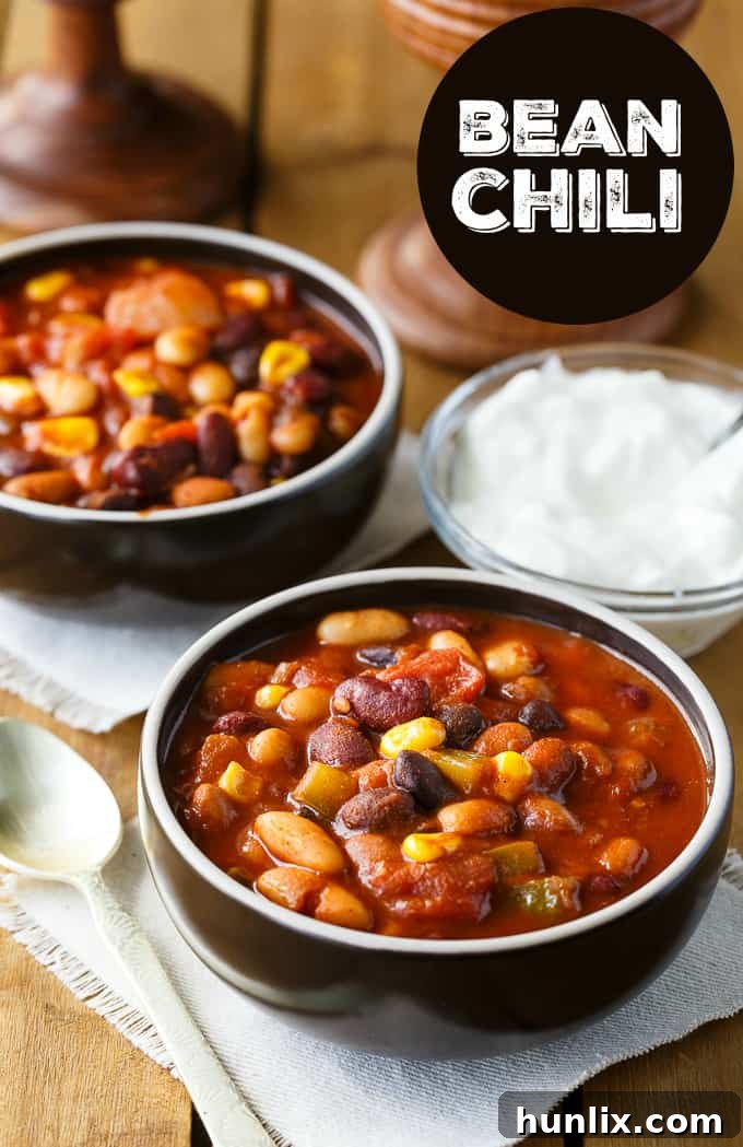 Hearty Bean Chili 5 Bean Chili - The heartiest meat-free chili recipe! Use four different kinds of canned beans in this comfort food classic with peppers, corn, and tomatoes.