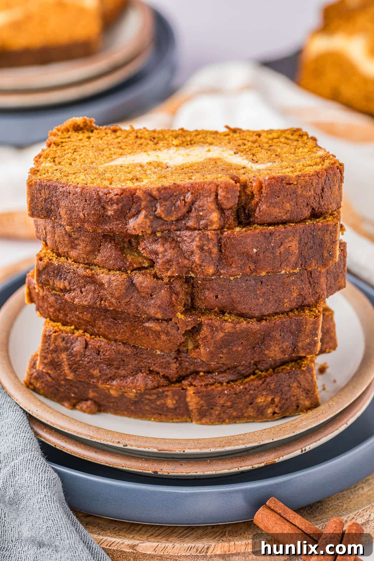 A perfectly stacked pile of pumpkin ribbon bread slices on a pristine white plate, ready to be enjoyed.