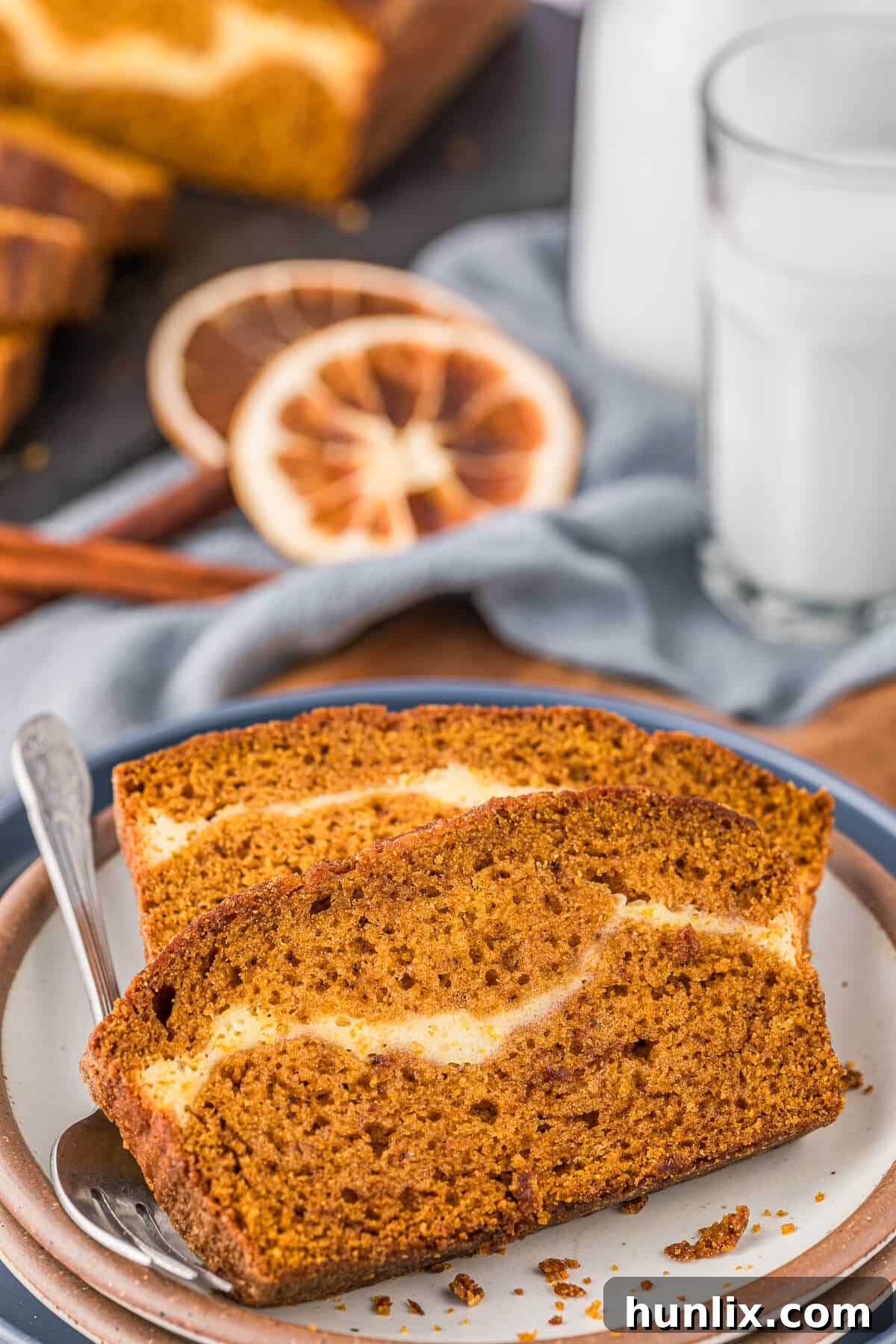 Two enticing slices of pumpkin ribbon bread resting on a plate with a fork, ready to be enjoyed.