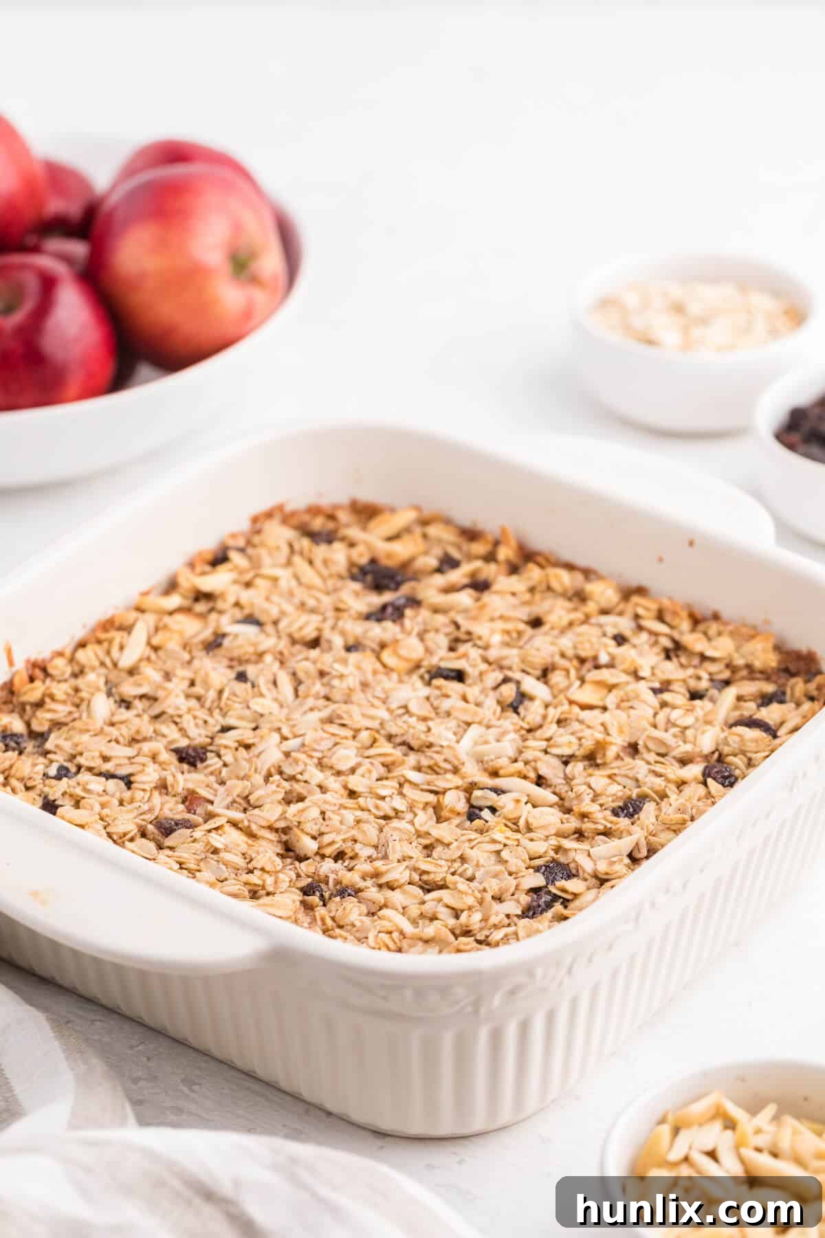 A full casserole pan of freshly baked oatmeal, topped with golden-brown crust and visible fruit, ready for serving.