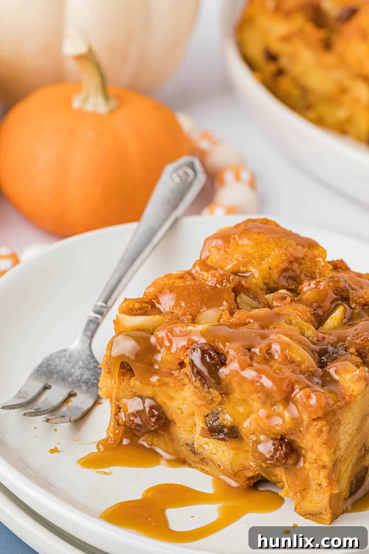 A perfectly portioned slice of moist Pumpkin Bread Pudding on a plate, highlighting its tender, spice-filled interior.