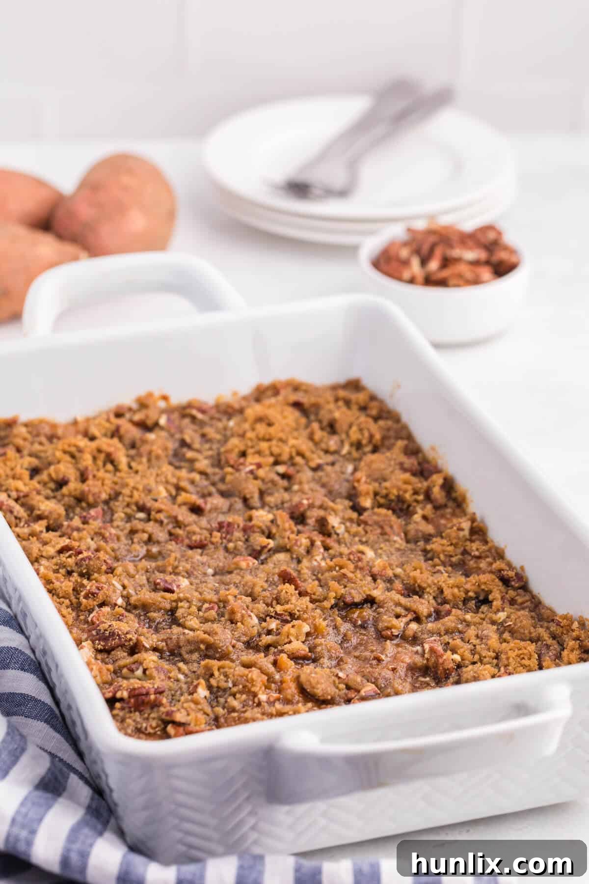 Golden Sweet Potato Delight 2 Sweet potato casserole in a white casserole pan, ready to be served.