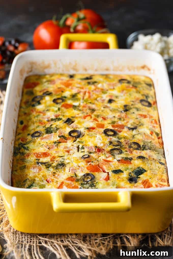 Mediterranean Sunrise Bake 2 Mediterranean Brunch Bake - A vibrant, healthy vegetarian egg casserole featuring feta, olives, fresh herbs, and colorful vegetables like zucchini, red and green peppers, and tomatoes, perfect for a holiday breakfast or brunch.