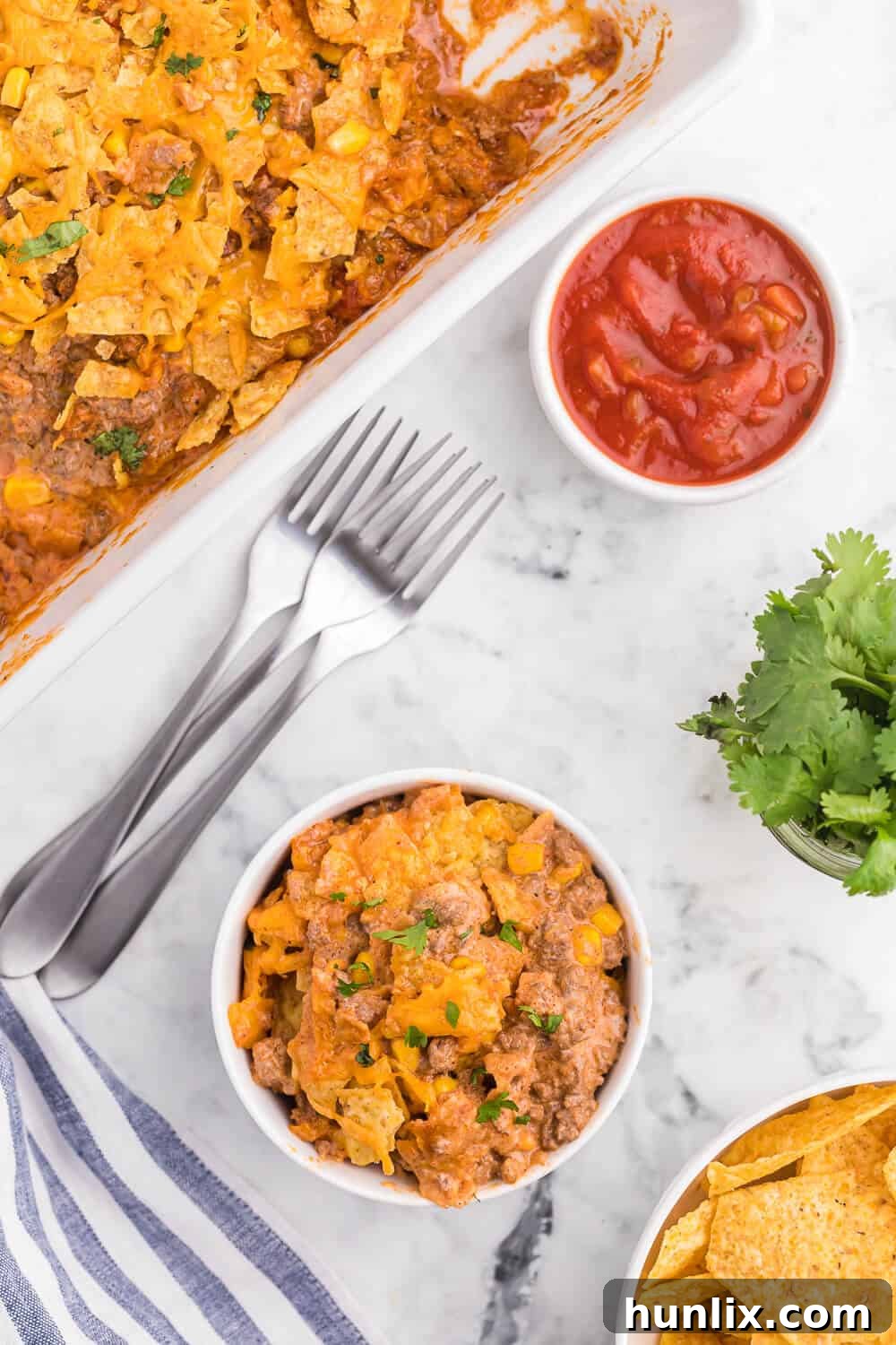 Fiesta Beef Nacho Bake 4 Beef nacho bake served in a bowl, showing the delicious layers of cheese, beef, and chips.