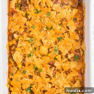 Fiesta Beef Nacho Bake 7 Beef Nacho Bake - This beefy nacho casserole is a welcome change from the traditional Taco Night. It hits all the right notes with cheese, beef, salsa and crunchy tortilla chips.