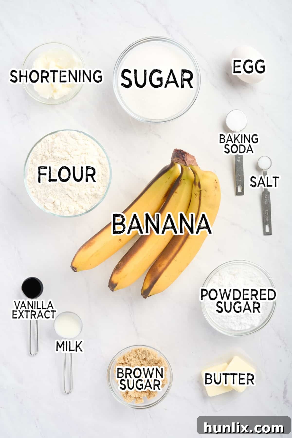 All the ingredients neatly laid out on a white surface, ready to be combined for caramel banana muffins.