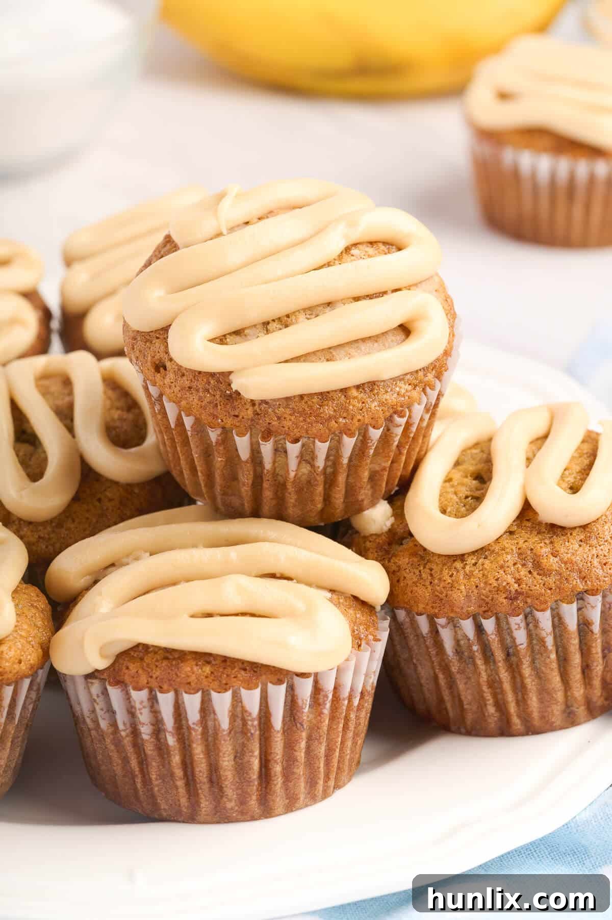 A beautiful stack of caramel banana muffins on a plate, ready to be enjoyed.