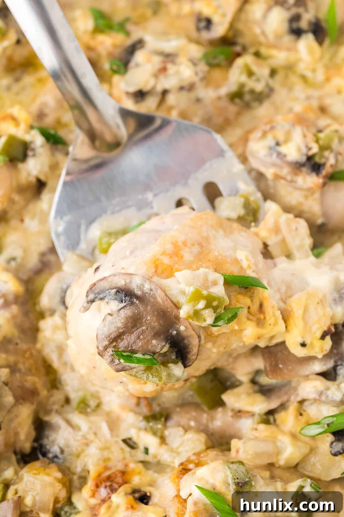 Tender Chicken in Rich Gravy 6 A generous serving of smothered chicken on a serving spoon, highlighting the rich, creamy gravy and tender chicken pieces.