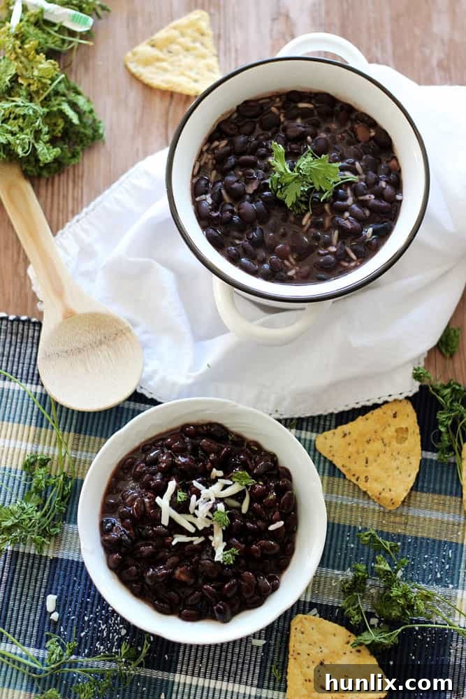 Slow Cooker Black Beans - Make the best dried black beans in the Crockpot! This bean recipe requires no soaking and simmers all day while you're at work for the easiest Taco Tuesday side dish.