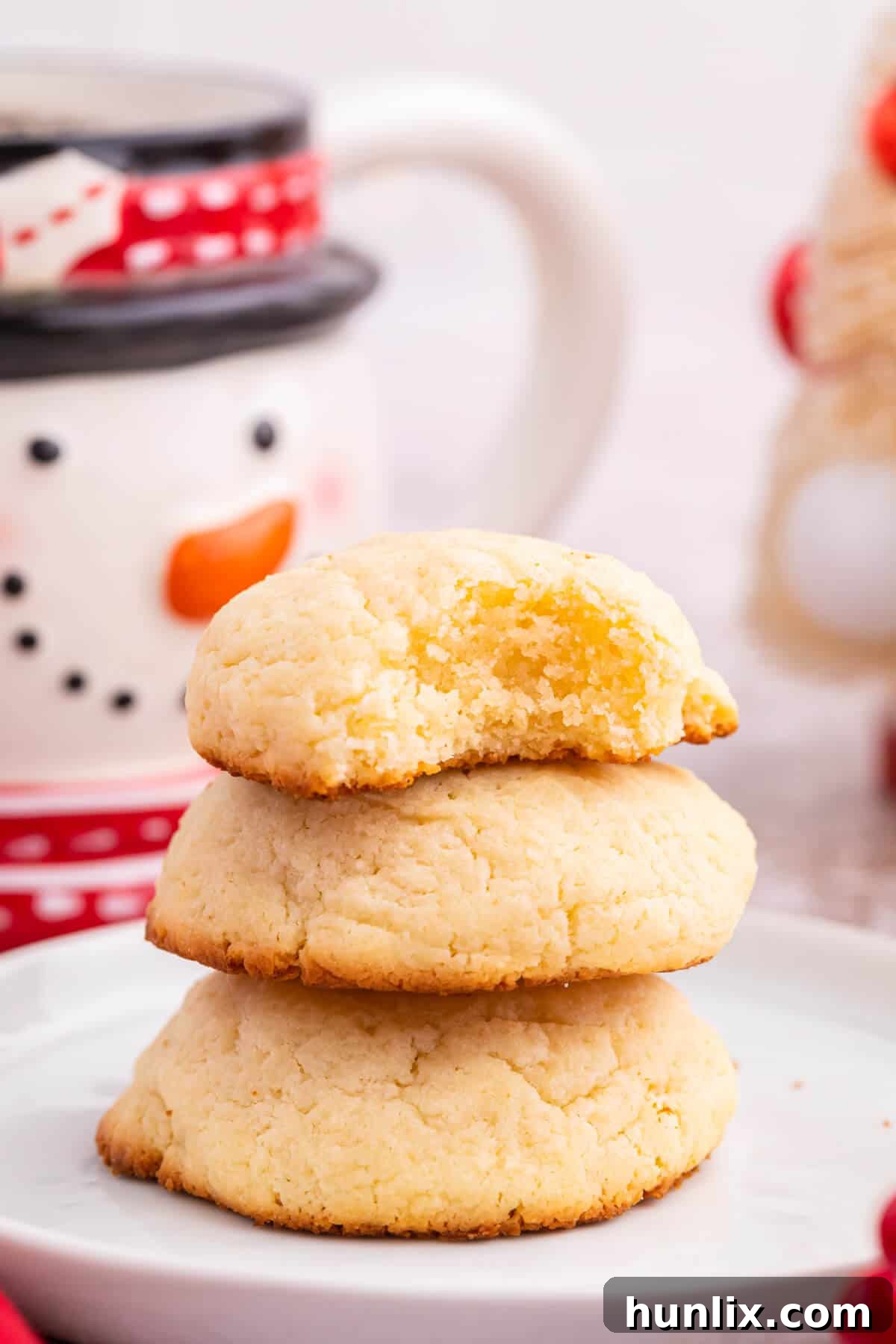 A neat stack of several cream cheese cookies, showcasing their soft texture.
