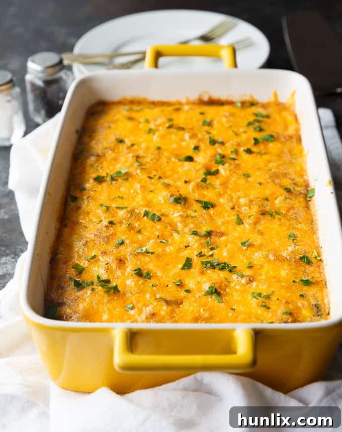 A perfectly baked Bacon, Spinach & Mushroom Crustless Quiche, golden brown and garnished with fresh parsley. This low-carb breakfast casserole is packed with flavor from bacon, spinach, mushrooms, onion, and cheddar cheese, offering a healthier twist on traditional quiche without the crust.