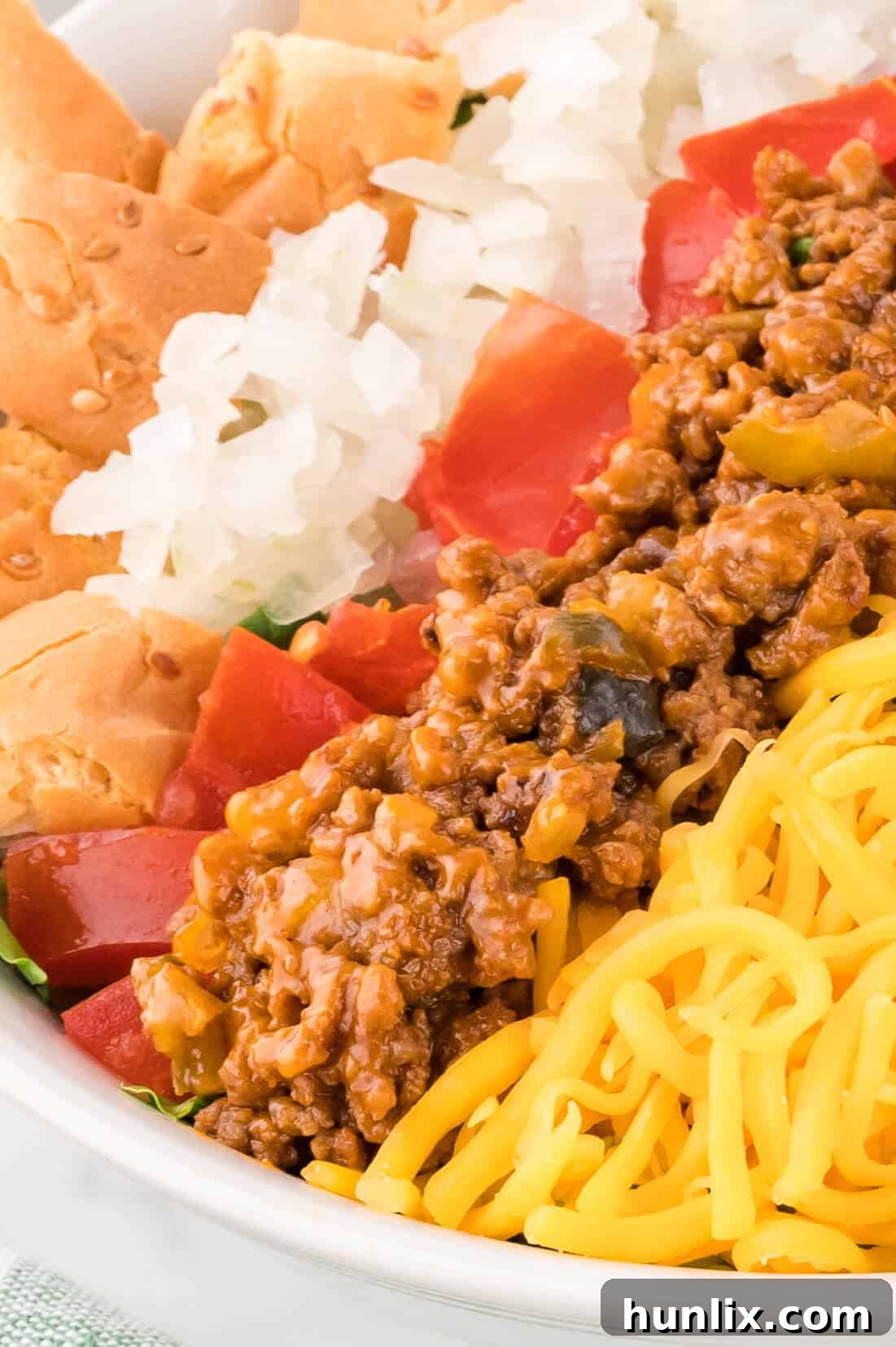 Cheeseburger in a Bowl 7 A close-up view of the vibrant cheeseburger salad, showcasing the detailed textures of the seasoned beef, melted cheese, and crisp greens, ready to be enjoyed.