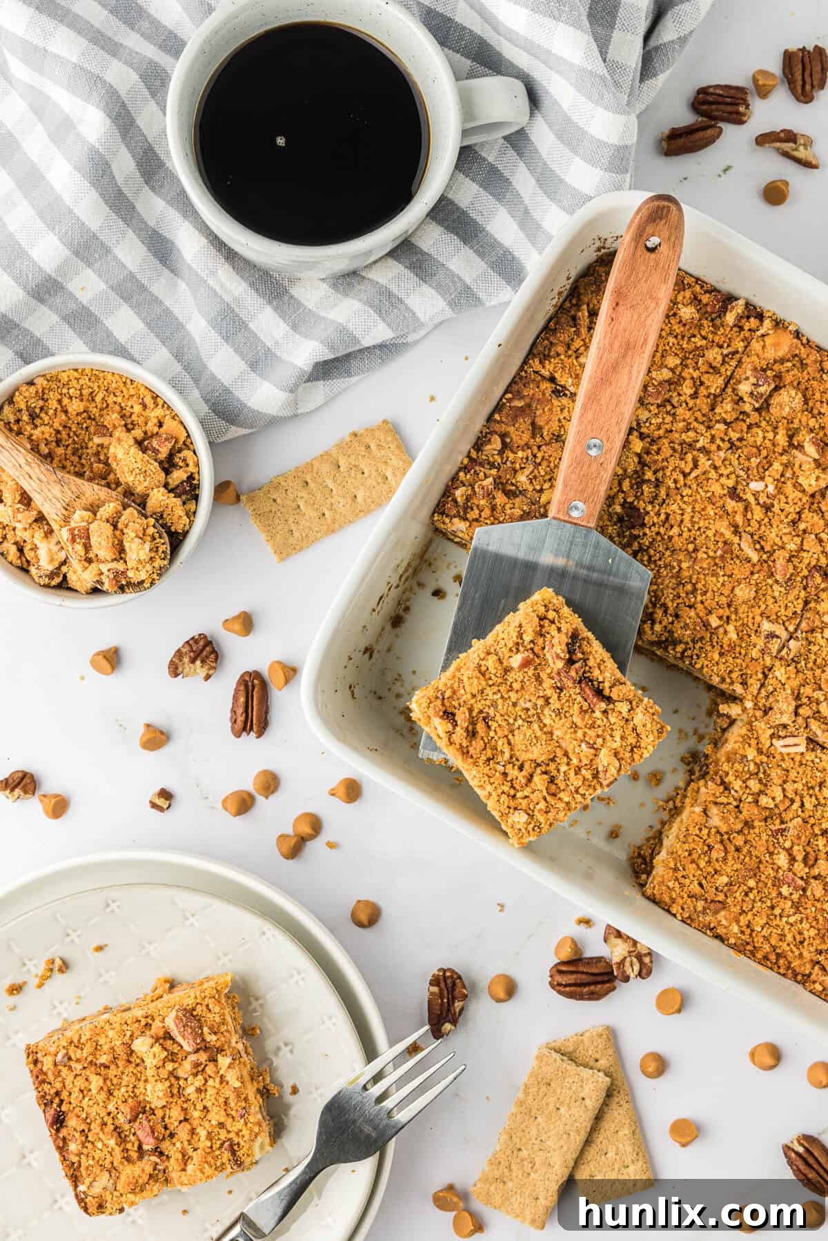 Dreamy Butterscotch Cheesecake Squares 8 Butterscotch cheesecake bars served directly in a baking pan with a spatula, indicating their readiness to be enjoyed.